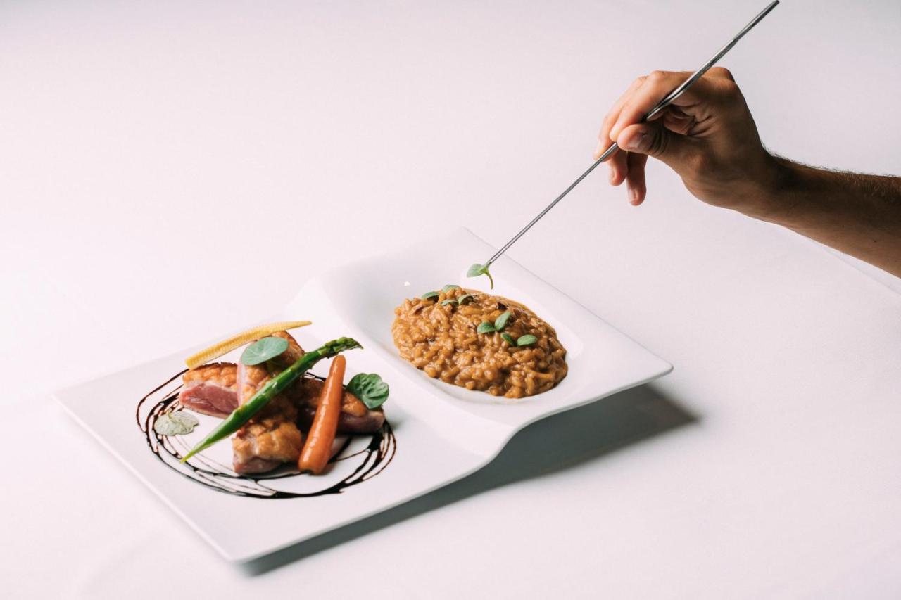 Montebelo Vista Alegre Ilhavo Hotel ภายนอก รูปภาพ A chef finishing a plate of food